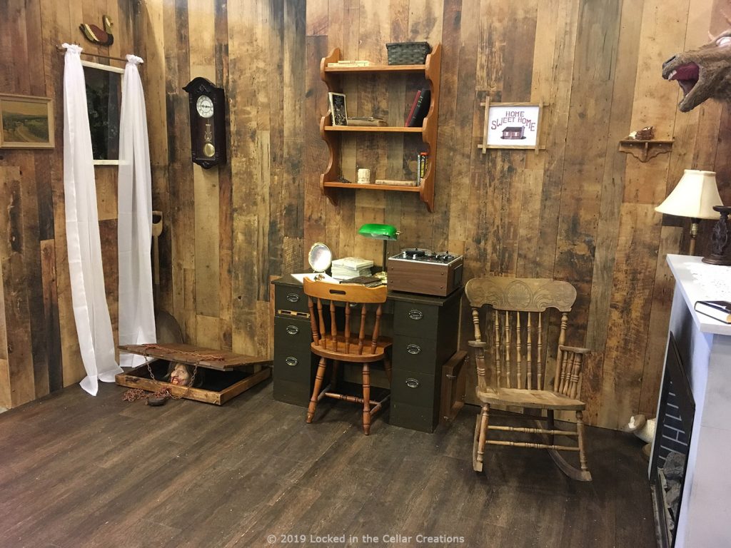 The cabin replica has 3 walls that are all covered with props/decor as seen in the movies