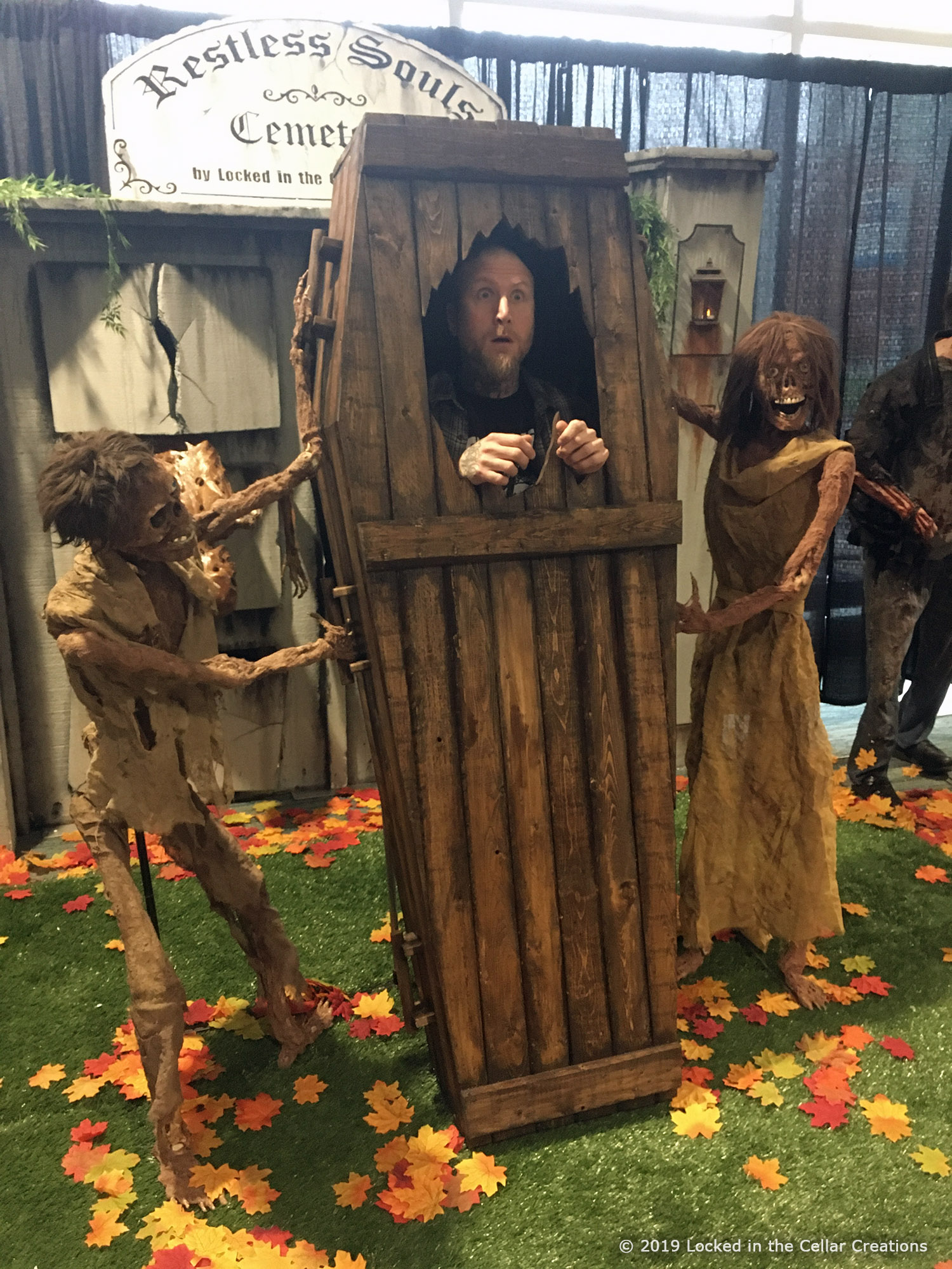 In the Exhumed Photo Experience, people can pose in this freshly dug up coffin held by two corpses.