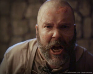 Close up of Keith Busher in Raullin make-up, featuring scars, boils, and a vein that's about to pop